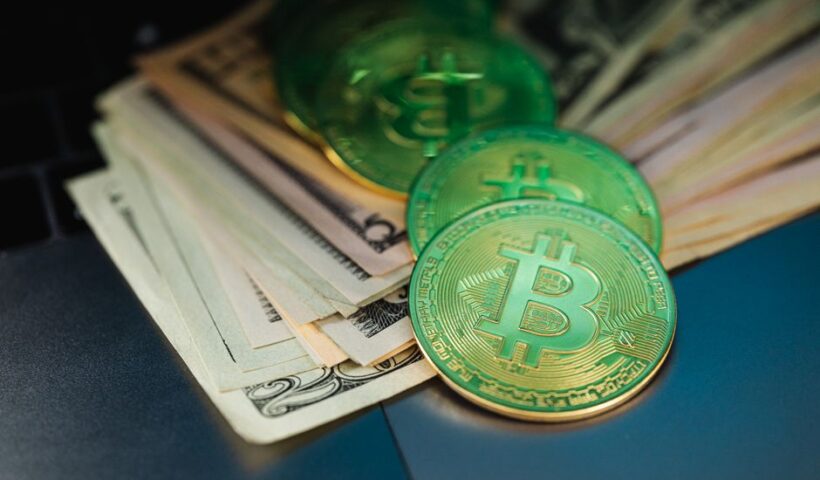 Bitcoin coin on semiconductor chips background with Japanese yen banknotes